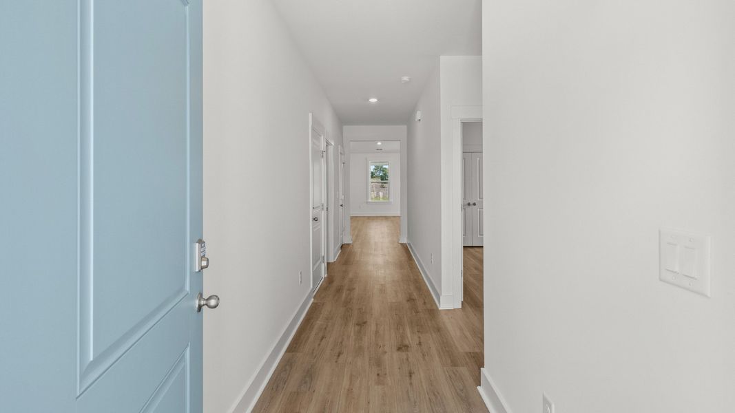 Bright entry hallway with durable LVP flooring leading into open living spaces. Bright entry hallway with durable LVP flooring leading into open living spaces.
