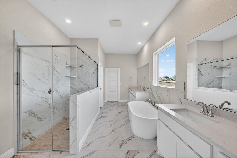 Full bathroom featuring two vanities, a soaking tub, a marble finish shower, light marble finish floors, and recessed lighting Full bathroom featuring two vanities, a soaking tub, a marble finish shower, light marble finish floors, and recessed lighting
