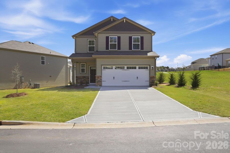 Front exterior of a new home in The Meadows at Asbury Ridge, York, SC, highlighting curb appeal (Image 2). Front exterior of a new home in The Meadows at Asbury Ridge, York, SC, highlighting curb appeal (Image 2).