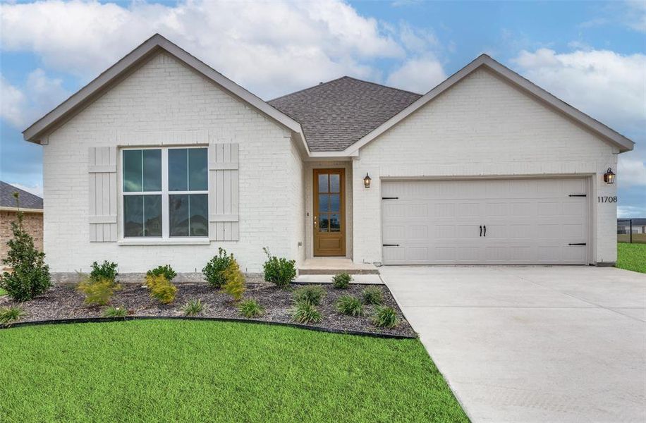 View of front facade with a front yard and a garage