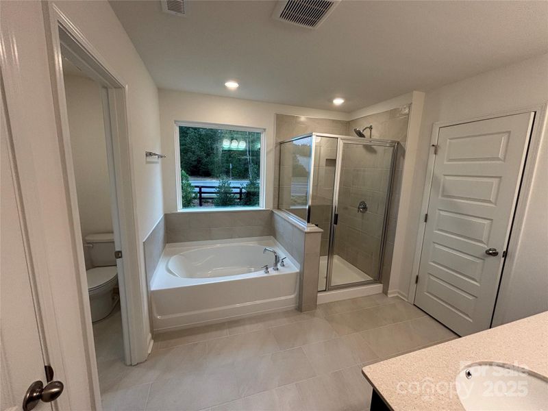 Primary Bath Features Private Water Closet, Large Garden Tub, Dual Sinks at Vanity and Linen Closet
