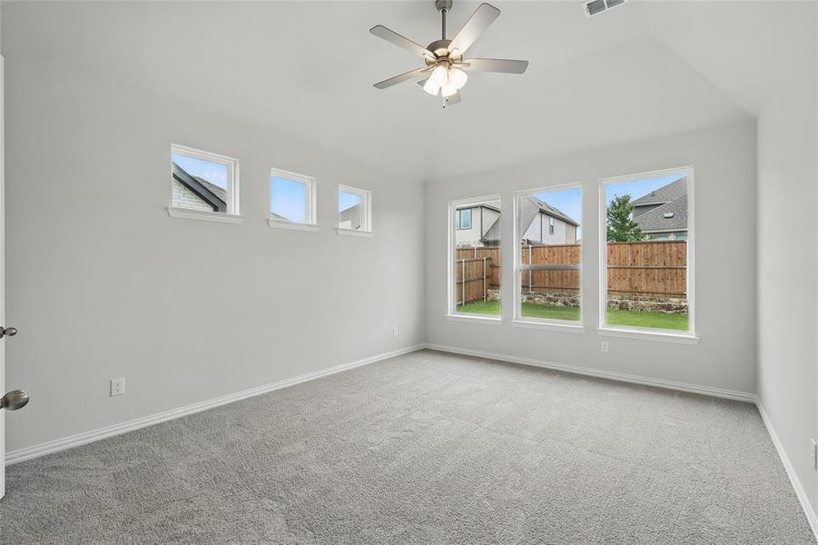 Carpeted spare room with baseboards and a ceiling fan Carpeted spare room with baseboards and a ceiling fan