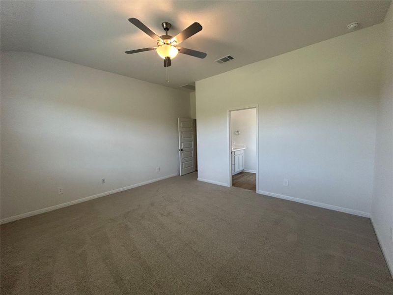 Empty room featuring carpet and a ceiling fan Empty room featuring carpet and a ceiling fan