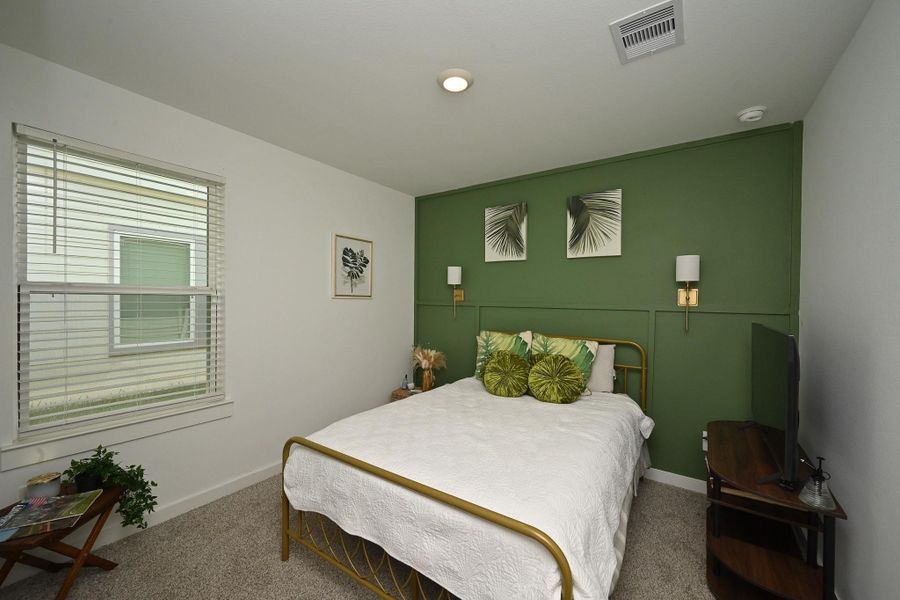 View of the beautiful 2nd bedroom with natural light creating a relaxing atmosphere. View of the beautiful 2nd bedroom with natural light creating a relaxing atmosphere.