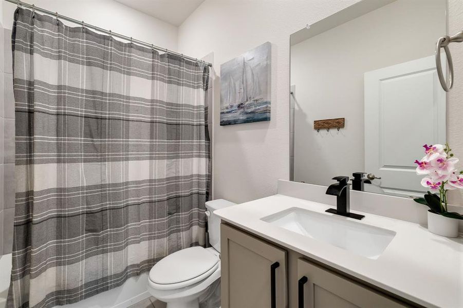 Full bathroom with vanity and shower / bath combo with shower curtain Full bathroom with vanity and shower / bath combo with shower curtain