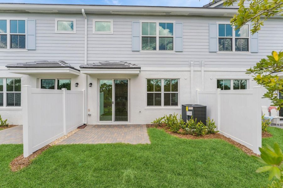 Front exterior of a new home in Salerno Reserve Townhomes, Stuart, FL, highlighting curb appeal (Image 23).