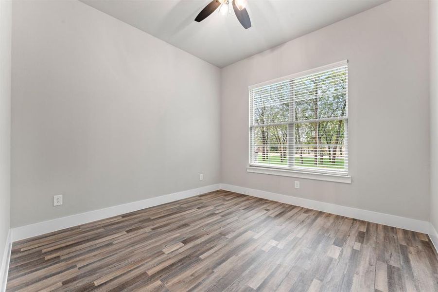 Spare room featuring hardwood / wood-style floors and ceiling fan