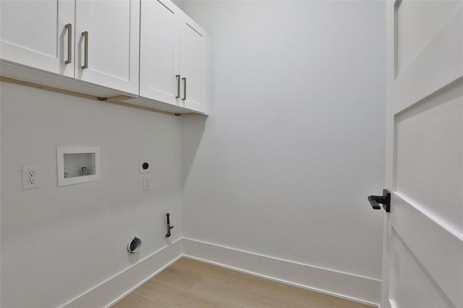 Convenient third-floor laundry space with ample built-in storage.