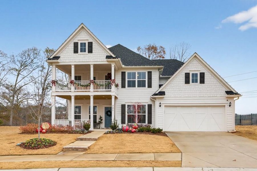 Front exterior of a new home in Reunion, Flowery Branch, GA, highlighting curb appeal (Image 1). Front exterior of a new home in Reunion, Flowery Branch, GA, highlighting curb appeal (Image 1).
