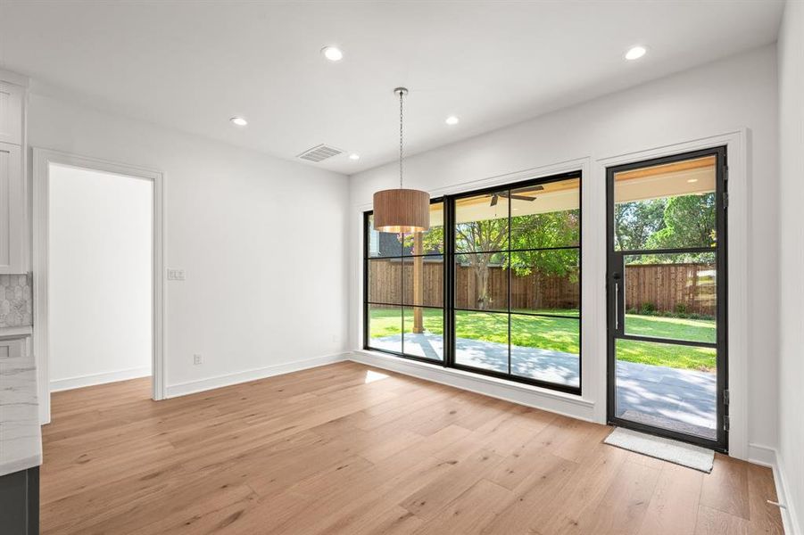 Unfurnished dining area featuring recessed lighting and light wood-type flooring Unfurnished dining area featuring recessed lighting and light wood-type flooring