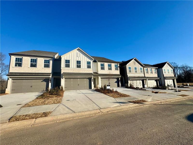 Front exterior of a new home in Eastlyn Crossing, Flowery Branch, GA, highlighting curb appeal (Image 1). Front exterior of a new home in Eastlyn Crossing, Flowery Branch, GA, highlighting curb appeal (Image 1).