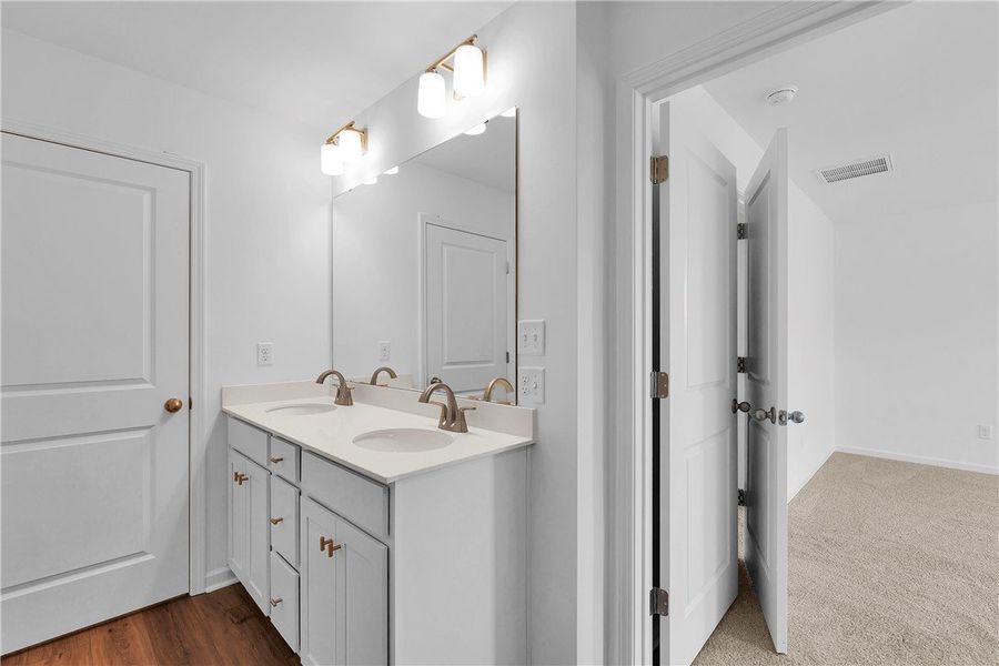 This spacious bathroom offers a double vanity and