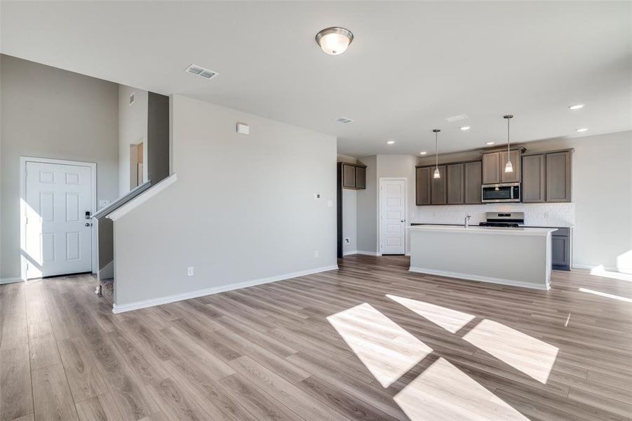 Unfurnished living room featuring light wood-type flooring and recessed lighting Unfurnished living room featuring light wood-type flooring and recessed lighting