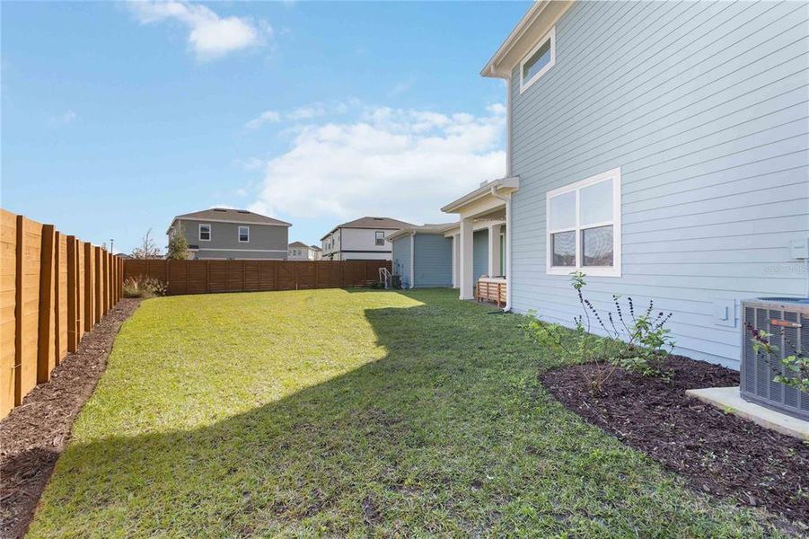 Exterior details and patio area of a home in Weslyn Park at Sunbridge (Craft Homes), St. Cloud (Image 4).