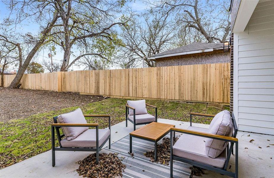 Wooden deck featuring a fenced backyard and a patio area