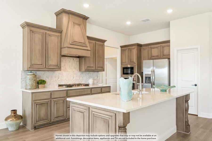 Kitchen with tan wood cabinets, decorative range hood, tile backsplash, and large center island with white countertops Kitchen with tan wood cabinets, decorative range hood, tile backsplash, and large center island with white countertops