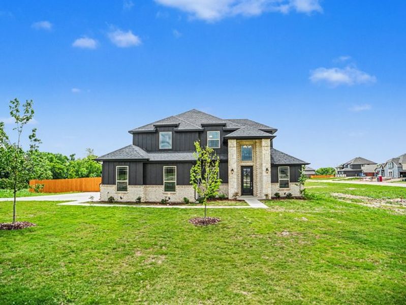 Front exterior of a new home in Ten Mile Creek Estates, DeSoto, TX, highlighting curb appeal (Image 1). Front exterior of a new home in Ten Mile Creek Estates, DeSoto, TX, highlighting curb appeal (Image 1).