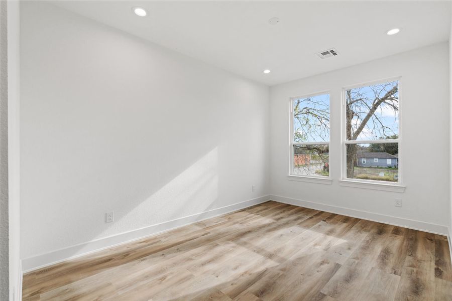 Spacious secondary bedroom with large windows and great natural light.