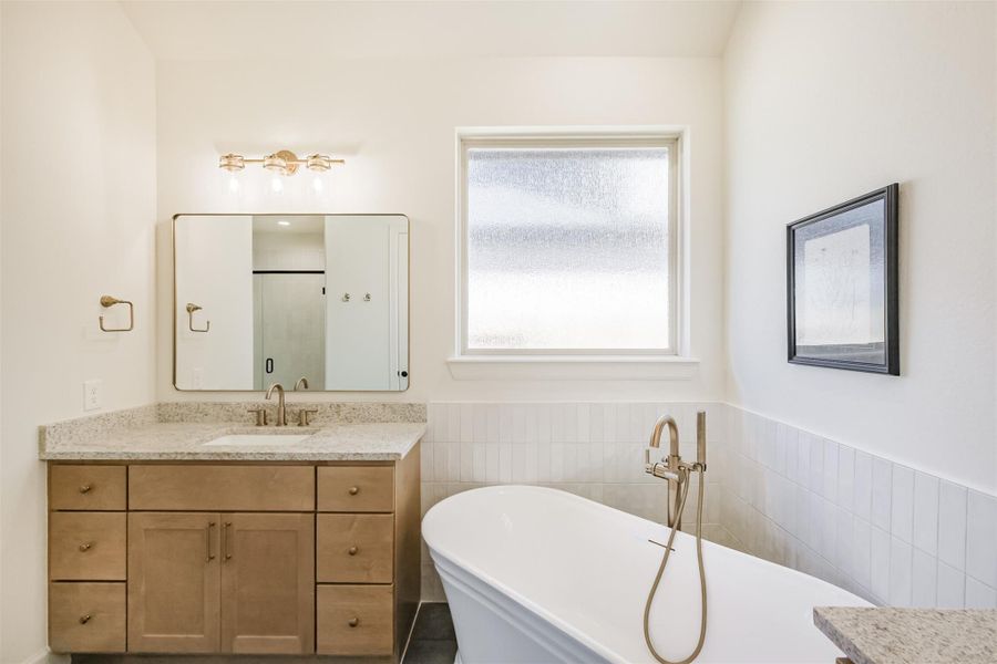 Prepare to treat yourself to the spa-like soaking tub surrounded by a tasteful wall tile selection.