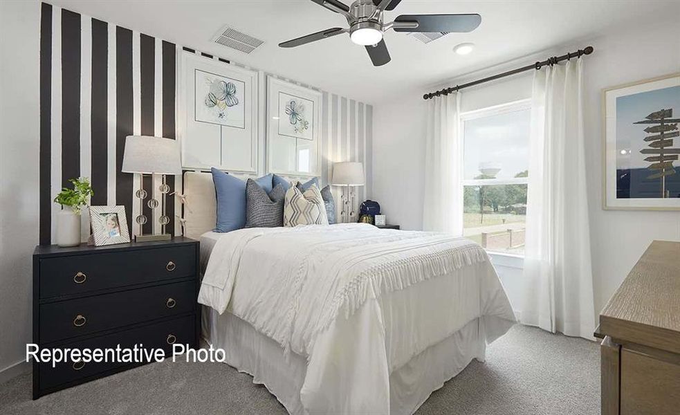Bedroom featuring a striped accent wall, ceiling fan, carpet flooring, a window with curtain rod, and a built-in light fixture