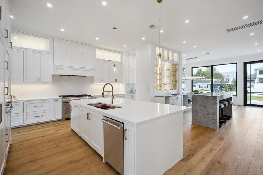 Another angle of the gourmet kitchen with oversized island, quartz counters, and designer pendant lighting. Another angle of the gourmet kitchen with oversized island, quartz counters, and designer pendant lighting.