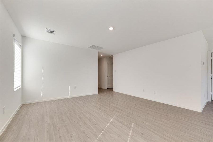 Unfurnished room with light hardwood / wood-style floors