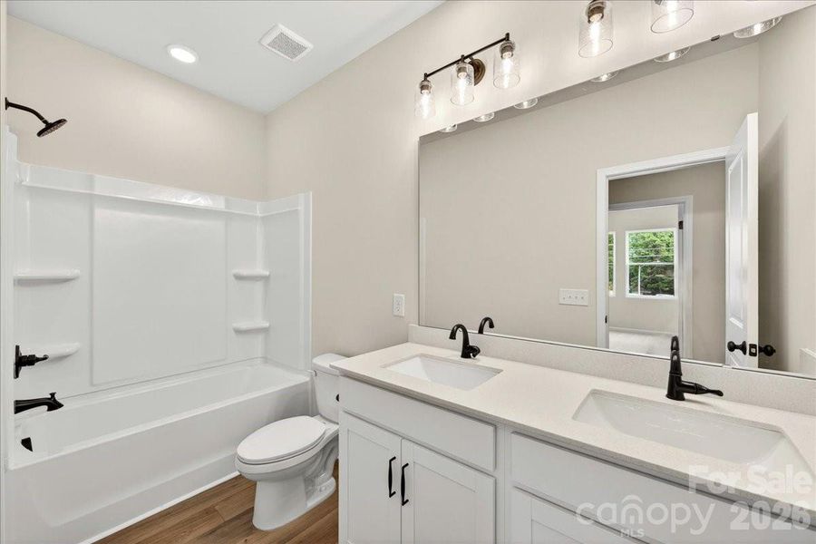 Dual vanity secondary bathroom with lights above the sink Dual vanity secondary bathroom with lights above the sink