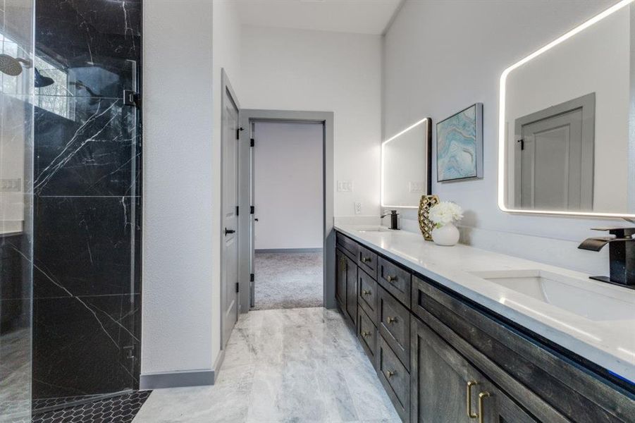 Bathroom featuring an enclosed shower and vanity