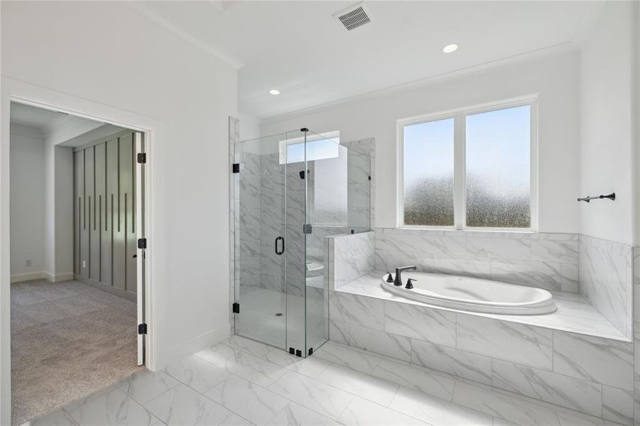 Bathroom with ornamental molding, tile patterned flooring, a healthy amount of sunlight, and plus walk in shower