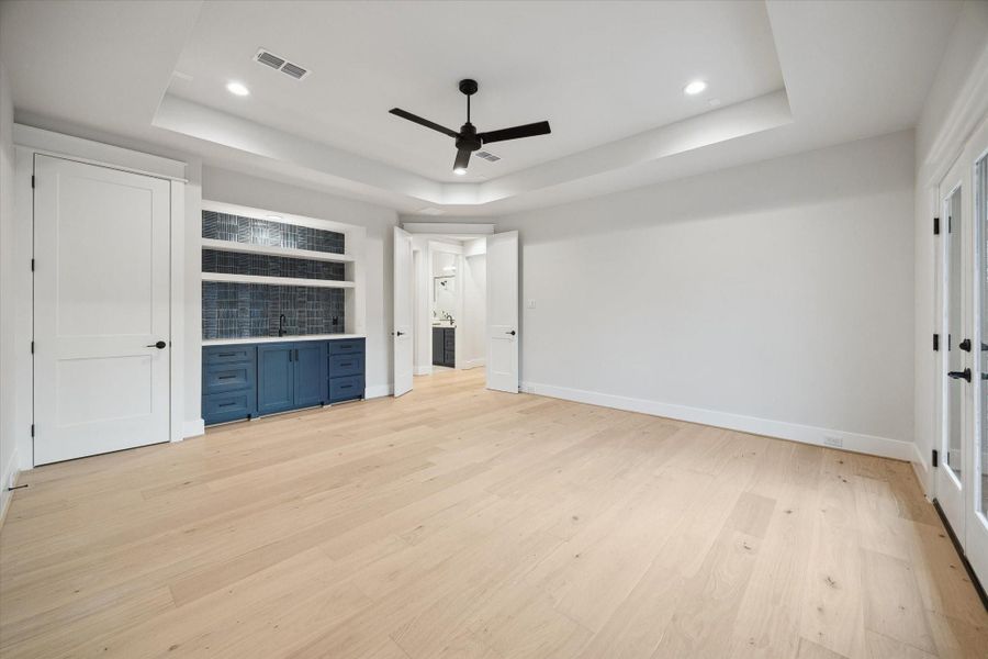 The game room has a wet bar with storage and media closet.