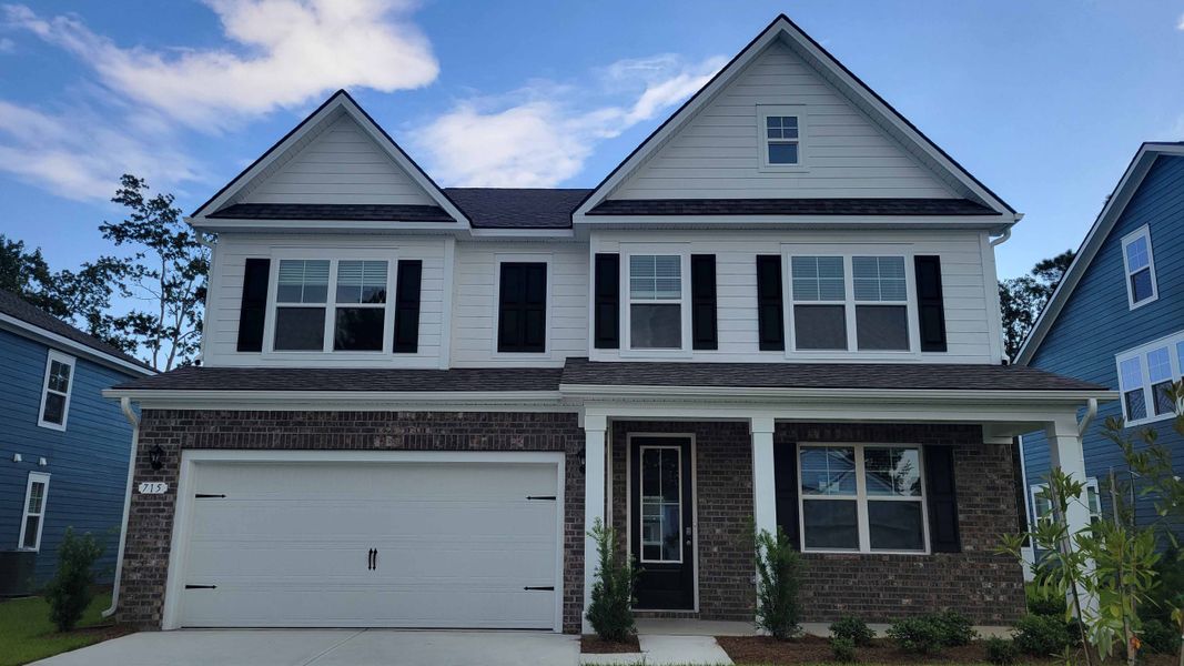 Front exterior of a new home in Heron Pointe, Myrtle Beach, SC, highlighting curb appeal (Image 1). Front exterior of a new home in Heron Pointe, Myrtle Beach, SC, highlighting curb appeal (Image 1).