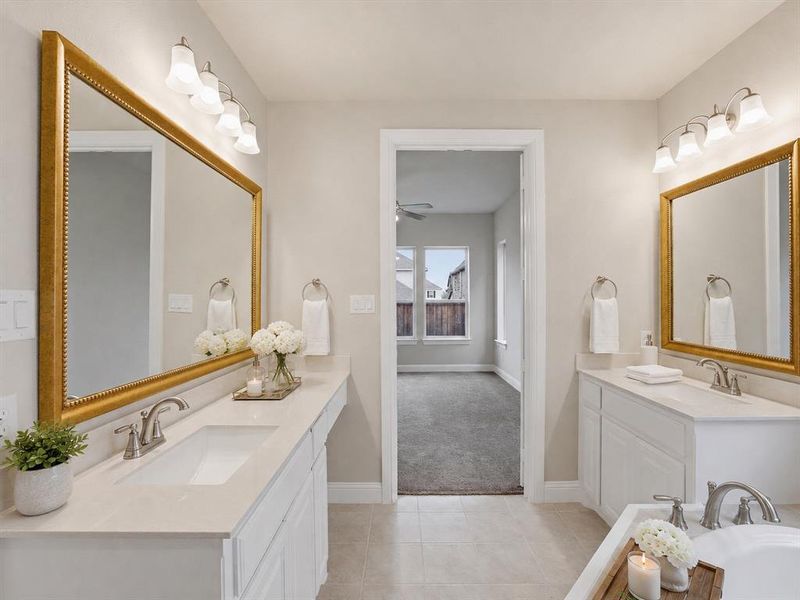Dual vanity bathroom featuring light neutral walls and tiled flooring Dual vanity bathroom featuring light neutral walls and tiled flooring