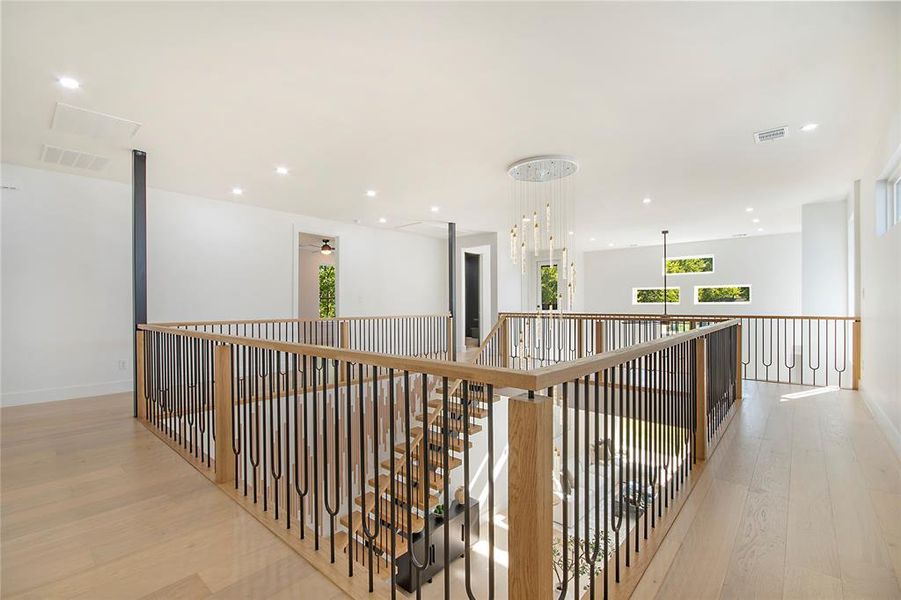 Hallway with light wood-style flooring and recessed lighting Hallway with light wood-style flooring and recessed lighting