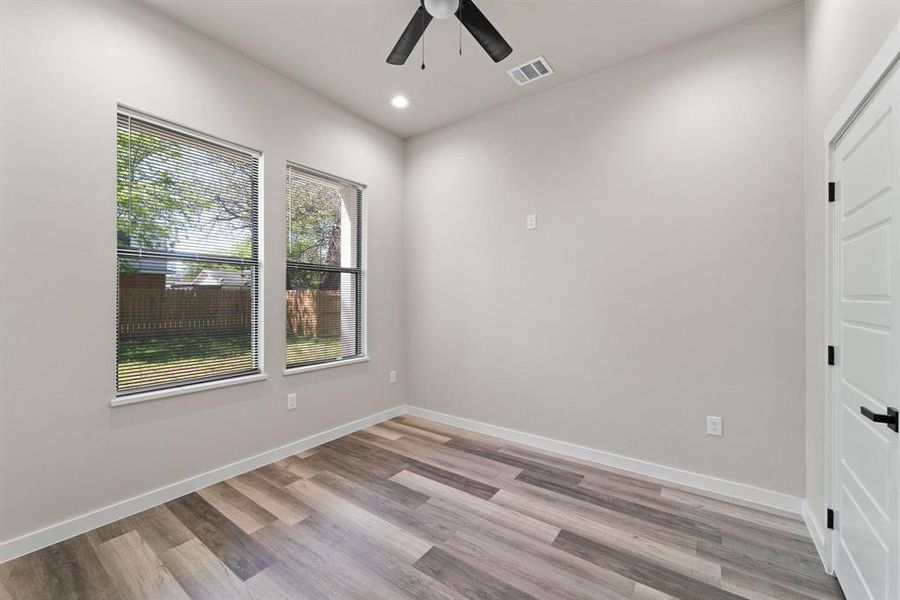 Spare room featuring light wood-type flooring and ceiling fan