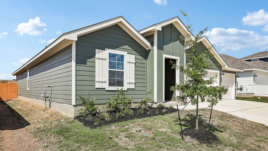 Front exterior of a new home in Prairie Lakes, Buda, TX, highlighting curb appeal (Image 22).