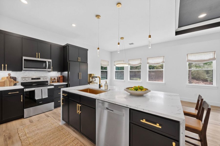 Culinary excellence awaits in this well-appointed kitchen, showcasing sleek cabinetry and a generously sized island.