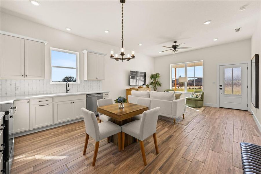 Open-concept living area featuring wood-finish flooring, recessed lighting, and a contemporary ceiling fan