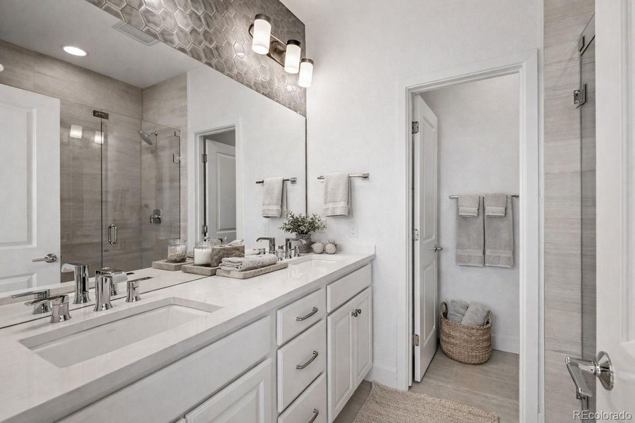 Large ensuite with upgraded tile and  frameless Euro shower. Virtually Staged.