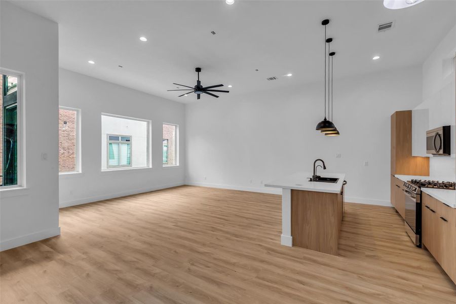 Large windows fill the kitchen and living area with natural light, creating an open and inviting atmosphere. Large windows fill the kitchen and living area with natural light, creating an open and inviting atmosphere.