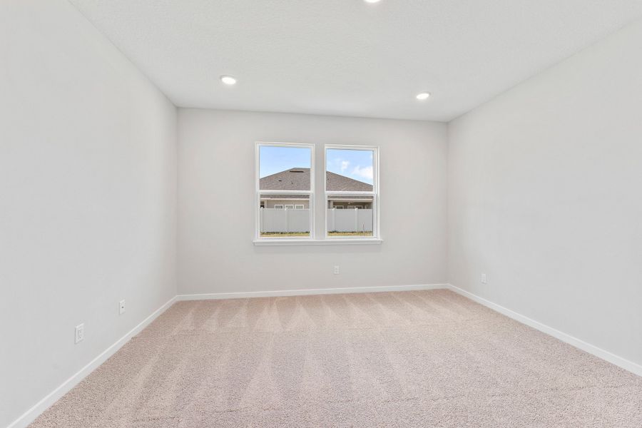 Primary Bedroom with Large Windows in Lot 19 Cedar II at Camden Woods in Kingsland, GA