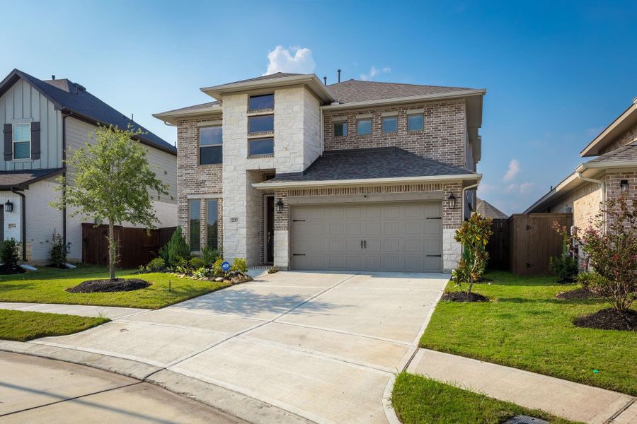 Front exterior of a new home in Cane Island 50', Katy, TX, highlighting curb appeal (Image 22). Front exterior of a new home in Cane Island 50', Katy, TX, highlighting curb appeal (Image 22).