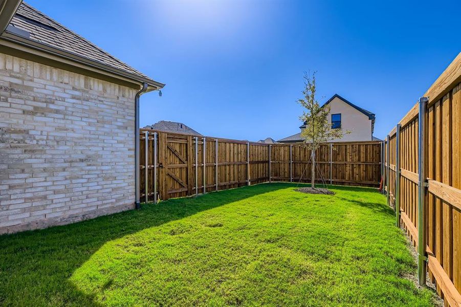 Fenced backyard featuring a gate Fenced backyard featuring a gate