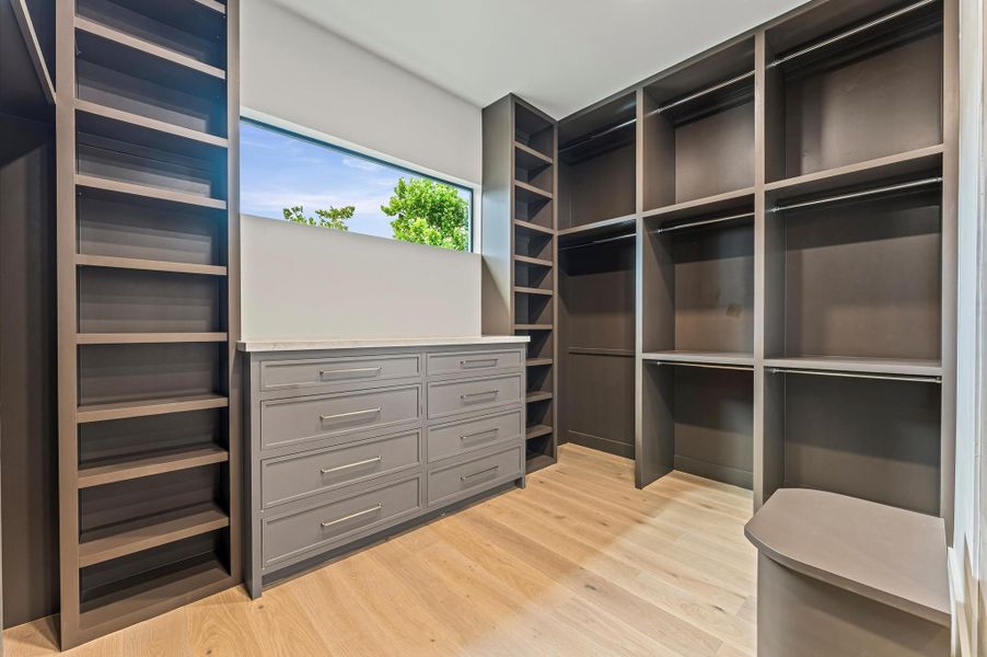 The custom built-in dresser with a Taj Mahal quartzite countertop adds a touch of elegance to the space. The custom built-in dresser with a Taj Mahal quartzite countertop adds a touch of elegance to the space.