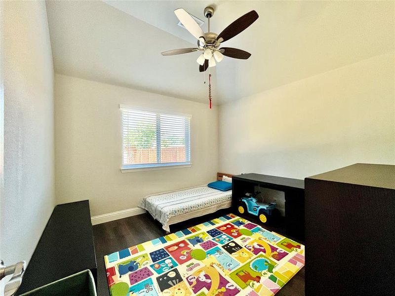 Bedroom featuring ceiling fan and wood-type flooring