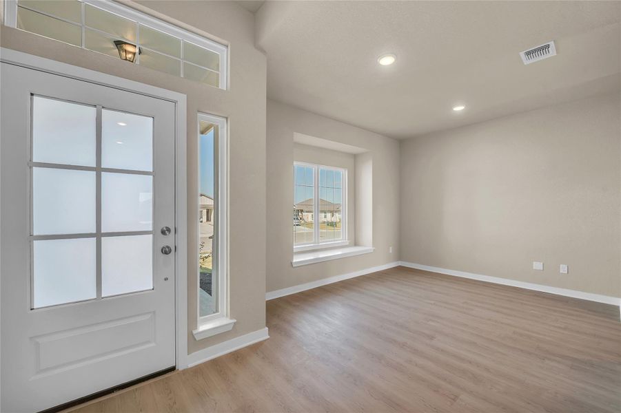 Foyer entrance featuring light wood-style floors and recessed lighting
