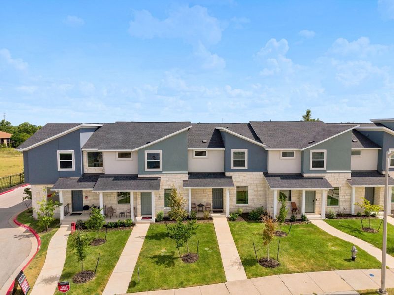 Neat concrete walkways lead to the covered entries of these modern multi-level townhomes.