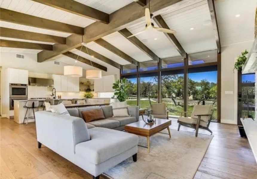 Living room with light wood-style floors and floor to ceiling windows Living room with light wood-style floors and floor to ceiling windows