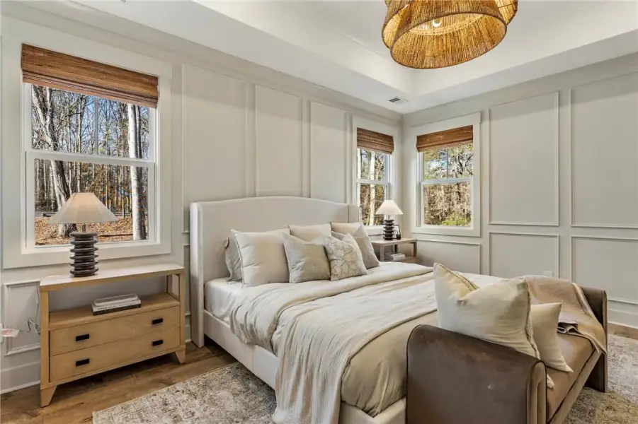This serene primary bedroom retreat features a tra