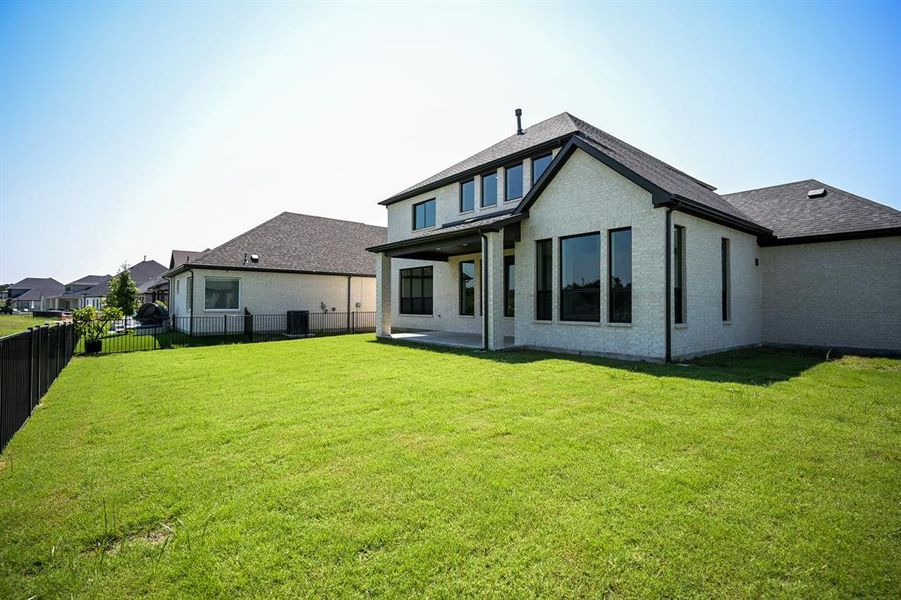 Rear view of house with plenty of yard for a pool or other recreation