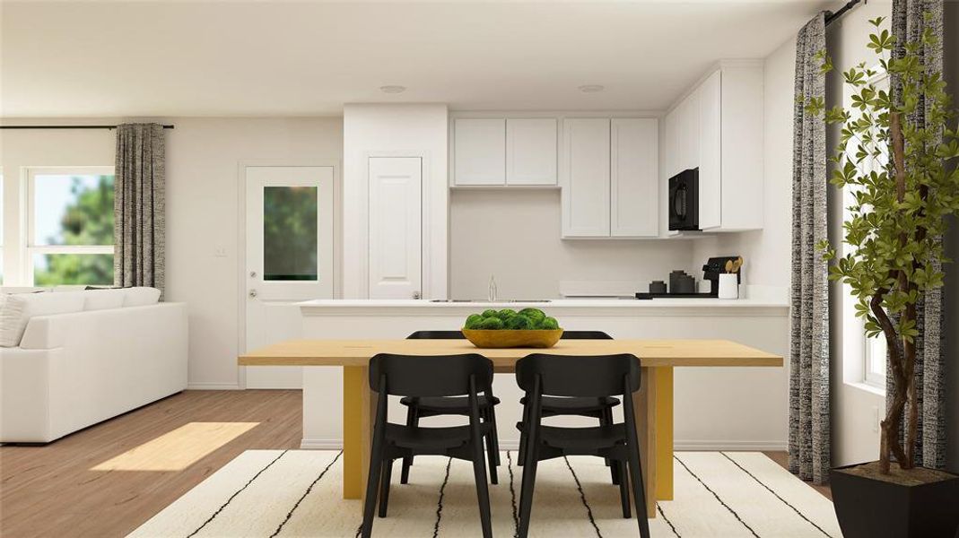 Kitchen with light hardwood / wood-style floors, sink, and white cabinets